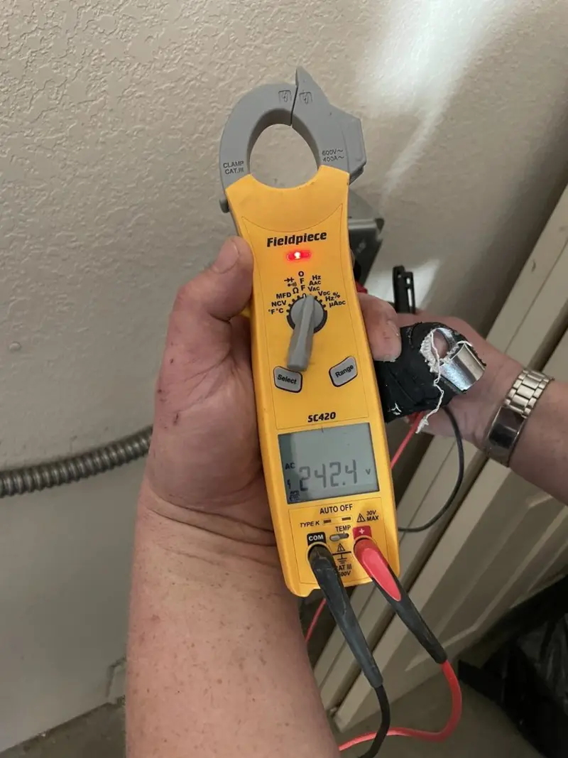 Voltage testing with clamp meter during Outlet Installation in Frankfort